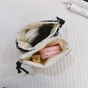 Macro shot of tweed coin purses showing internal storage for lipstick and cushions
