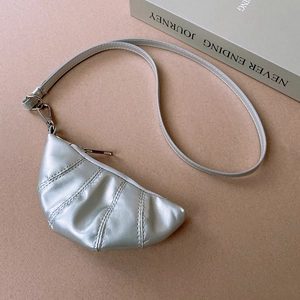Detailed view of silver croissant-shaped pendant on high-quality faux leather necklace