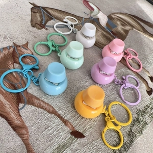 Close-up of colorful round mini stapler keychains in pastel macaron shades on carpet