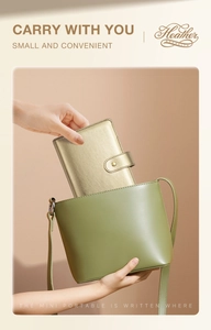 Champagne gold cross-grain notebook being placed into a small green handbag
