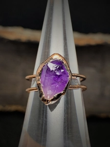 Close-up of irregular raw amethyst stone on copper double-layer band ring