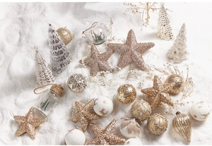 Detail of glittered star tree topper and festive ornaments on white artificial snow