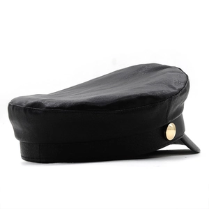 Detail of black faux leather baker boy hat with golden side button decoration