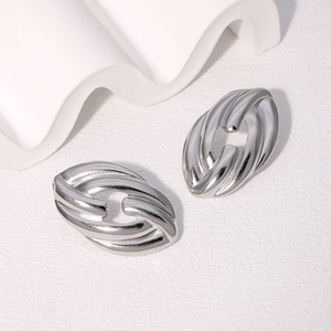 Pair of minimalist silver-colored twisted oval hoop earrings in stainless steel