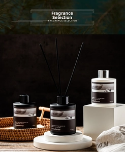 Three-piece reed diffuser set with 120ml black and white bottles on a woven tray