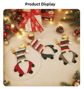 Detail showing festive gnome cutlery holders with striped knit hats on a Christmas table