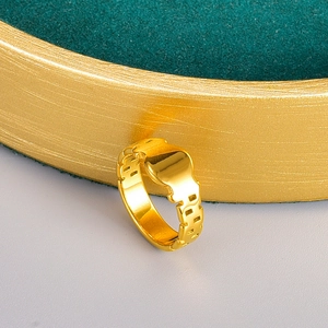 Modern gold plated stainless steel chunky chain link ring on luxury green display