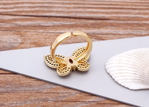 Close-up of 18K gold plated butterfly ring with micro-pave crystals and open band