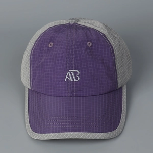 Detailed close-up of quick-dry checkered baseball cap with contrast panels and AB embroidery