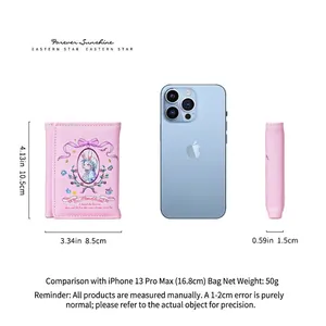 Pink trifold wallet with rabbit graphic next to iPhone for size comparison