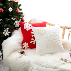 Christmas snowflake embroidered cushion covers in red and white with decorative pom-poms