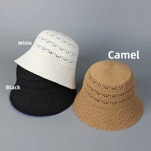 Detail of hollow knit bucket hats in white, black, and camel with breathable texture