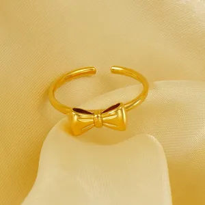 Elegant 18K gold-plated titanium steel bow ring with a matte finish and open adjustable size