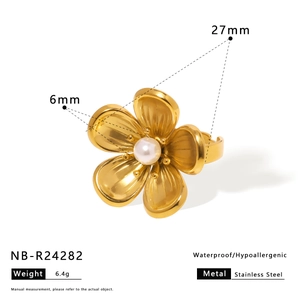 Macro view of gold-plated stainless steel flower ring with white pearl center and sizing info