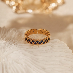 Detail of 18K gold-plated ring with heart-shaped settings and blue zircon stones