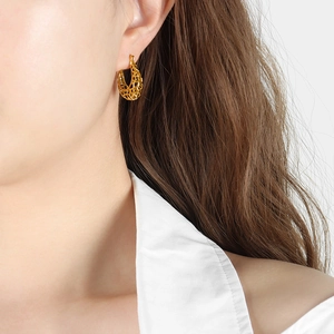 Baroque retro gold hollow U-shaped earrings displayed on a model for a luxury vintage look