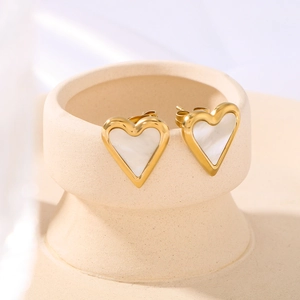 18k gold plated heart earrings with white shell inlay on a minimalist display stand