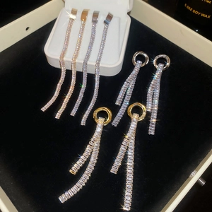 Detail of silver needle zircon tassel earrings set in gold and silver on black velvet