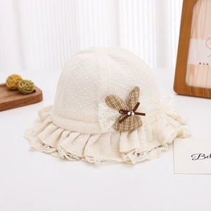 Detail of baby sun hat with lace brim and cute checkered bunny doll ornament