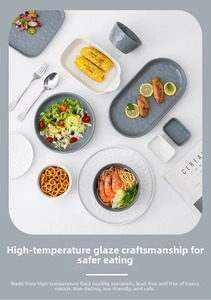 Flat lay of gray and white ceramic tableware set with elegant matte glazed finish