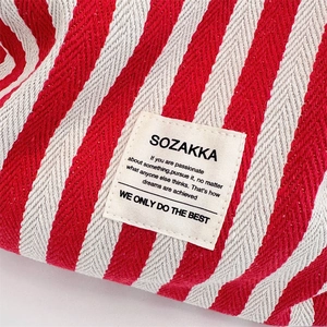 Detailed macro view of the striped canvas texture and square fabric label stitching