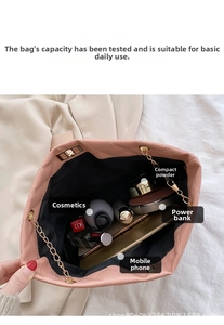 Interior view of pink quilted chain bag showing capacity for phone and cosmetics