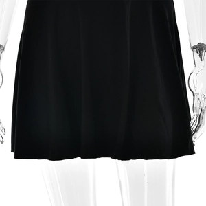 Detail of the soft black fabric and hemline of a sexy backless summer halter mini dress