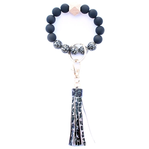 Detailed shot of leopard print silicone beads and PU leather tassel on keychain bracelet