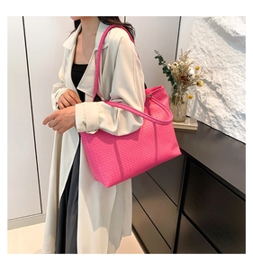 Detailed view of magenta woven tote bag texture and large shoulder strap capacity