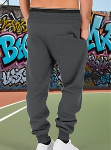 Rear view of men's dark grey jogger pants showing ribbed cuffs and back pocket detail