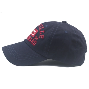 Close-up of deep blue cotton baseball cap with red 3D embroidery detail on the side