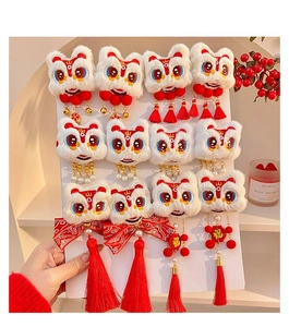 Detail of Chinese New Year lion dance hair clips with plush pom-poms and long tassels