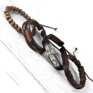 Detail of multi-layer leather bracelet set with wooden beads and turquoise cross charm
