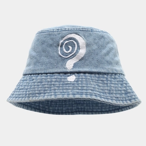Close-up of denim bucket hat with detailed white spiral question mark embroidery texture