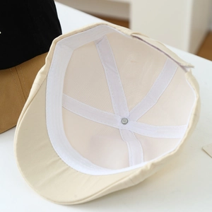Close-up of internal cotton lining stitching and sweatband of child baseball cap