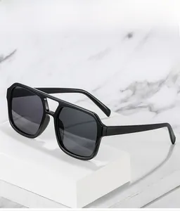 Detailed close-up of square double-bridge aviator sunglasses with black frames and lenses