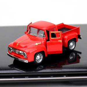 Macro shot of red vintage alloy pickup truck model with openable doors and chrome rims