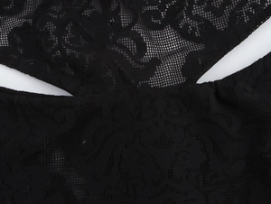 Detailed macro view of black lace fabric with floral embroidery and elegant mesh texture