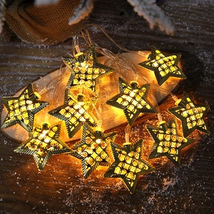 Warm white LED star string lights with hollow metal mesh design for festive Christmas decor