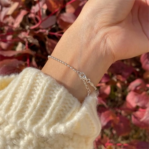Close-up of S925 sterling silver beaded bracelet with lobster clasp on a female wrist