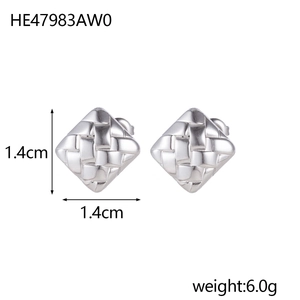 Macro shot of silver-colored square earrings featuring a classic woven pattern texture