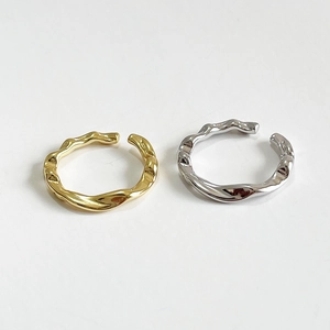 Minimalist irregular wavy open ring set in gold and silver finish on white background