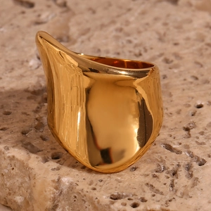 Macro shot of an irregular 18K gold plated stainless steel chunky ring on stone