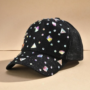 Close-up of a black baseball cap with iridescent rhinestones and shimmering fabric detail