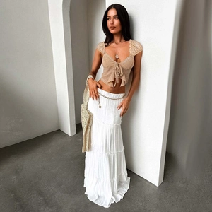Detail of lace crop top with bow tie and layered white maxi skirt for summer
