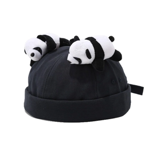Creative black docker hat featuring two cute panda plush decorations in a minimalist style