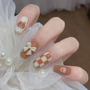 Cute brown press-on nails set featuring cartoon bear, 3D bow, and checkered patterns