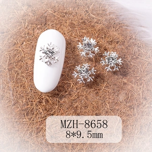 Macro view of 8x9.5mm silver snowflake nail art charms with center rhinestone detail