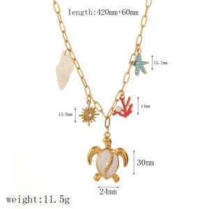Detailed view of sea turtle and seashell pendants on gold stainless steel link chain