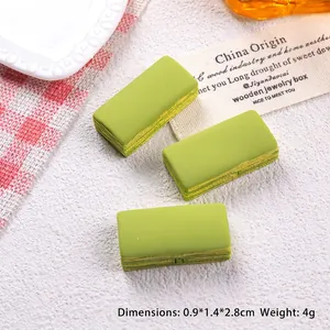 Detail of miniature matcha green cake resin charm showing realistic layered cake texture